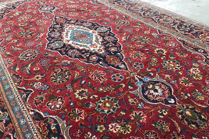 Close-up of an Oriental rug: red pattern, floral ornamentation, and ornate borders