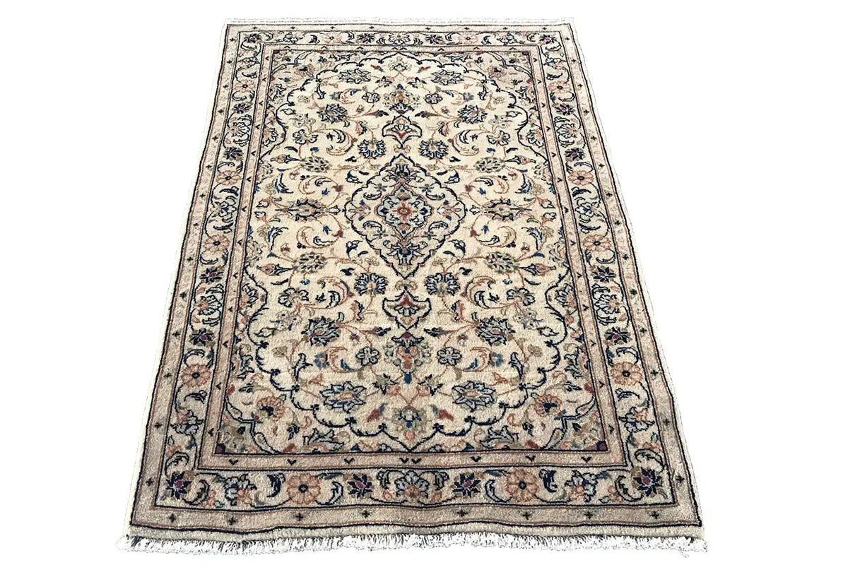 Beige Keshan rug with an ornamental floral pattern and dark border, with fringes
