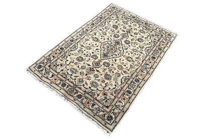 Rug with a light beige ground, decorative central medallion, and dark blue border.