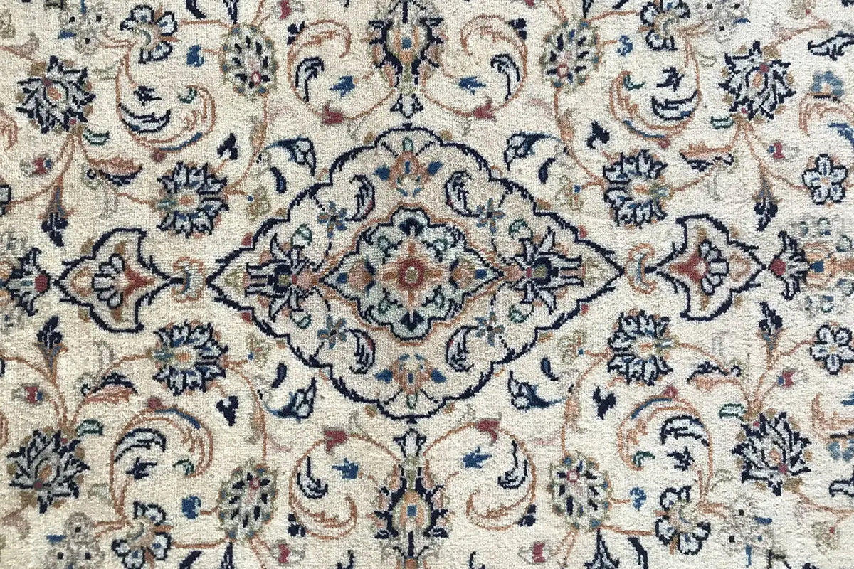 Close-up: Detailed floral pattern in beige, dark blue, and red accents in the field