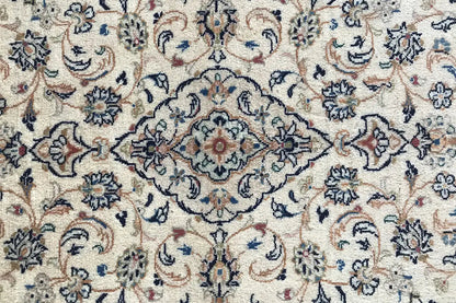 Close-up: Detailed floral pattern in beige, dark blue, and red accents in the field