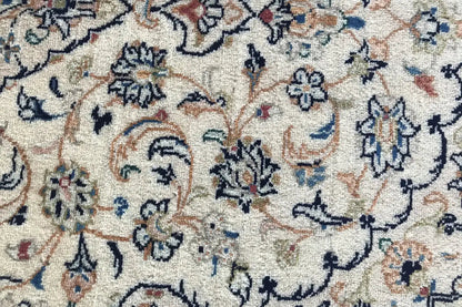 Close-up of the floral carpet pattern with dark blue and red contrast on a light background