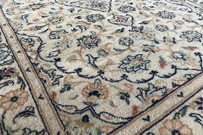Carpet detail with an ornamental striped border and many small floral motifs in the field