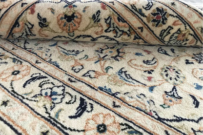 Carpet area with surrounding ornamental bands, floral motifs, and subtle color accents