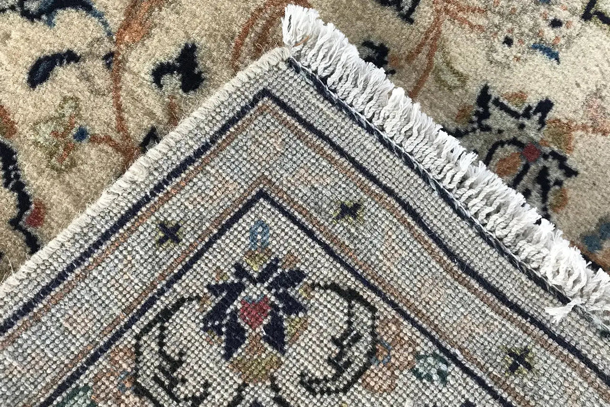 Close-up of the rug edge with fringes and a woven texture in a framed pattern