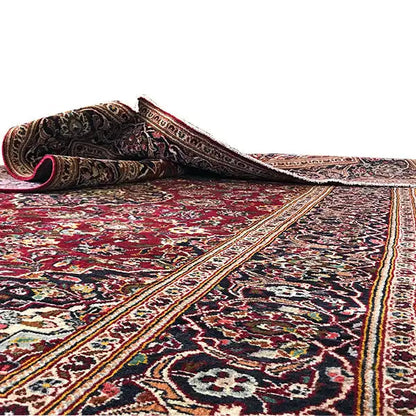 Red Oriental rug with a woven border and multicolored ornamental pattern