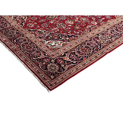 Red oriental rug corner with finely woven ornaments and multicolored edging