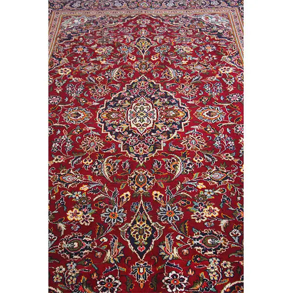 Red Oriental rug with a central medallion and rich floral ornament pattern