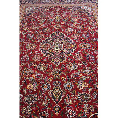 Red Oriental rug with a central medallion and rich floral ornament pattern