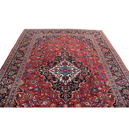 Keshan rug with a red background, dark medallion, and ornamental pattern