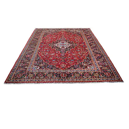 Keshan rug in red with medallion design, surrounding border, and ornamental motifs