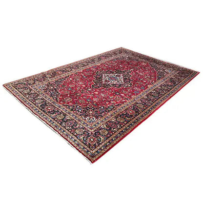 Red Keshan rug with a dark border pattern and floral ornaments