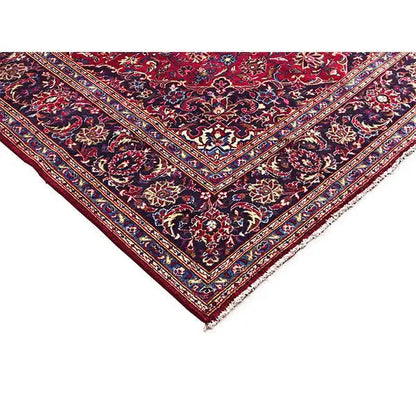 Red Keshan rug corner with a black floral pattern and multicolored border