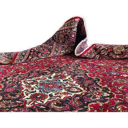 Keshan rug with a red pattern, rolled edge, and frayed border