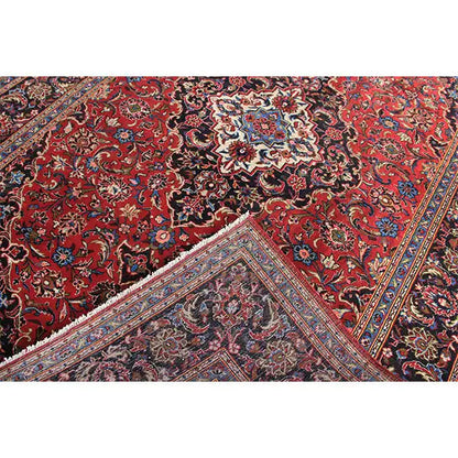 Keshan rug in red with a central medallion and intricate ornaments in detail