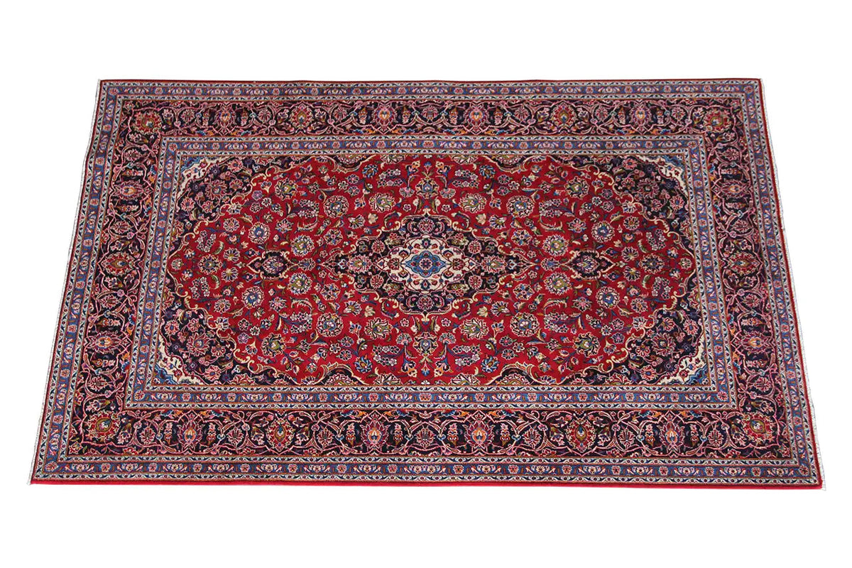 Keshan rug in red with a blue medallion and ornate border