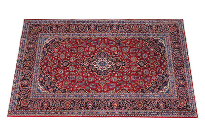 Keshan rug in red with a blue medallion and ornate border