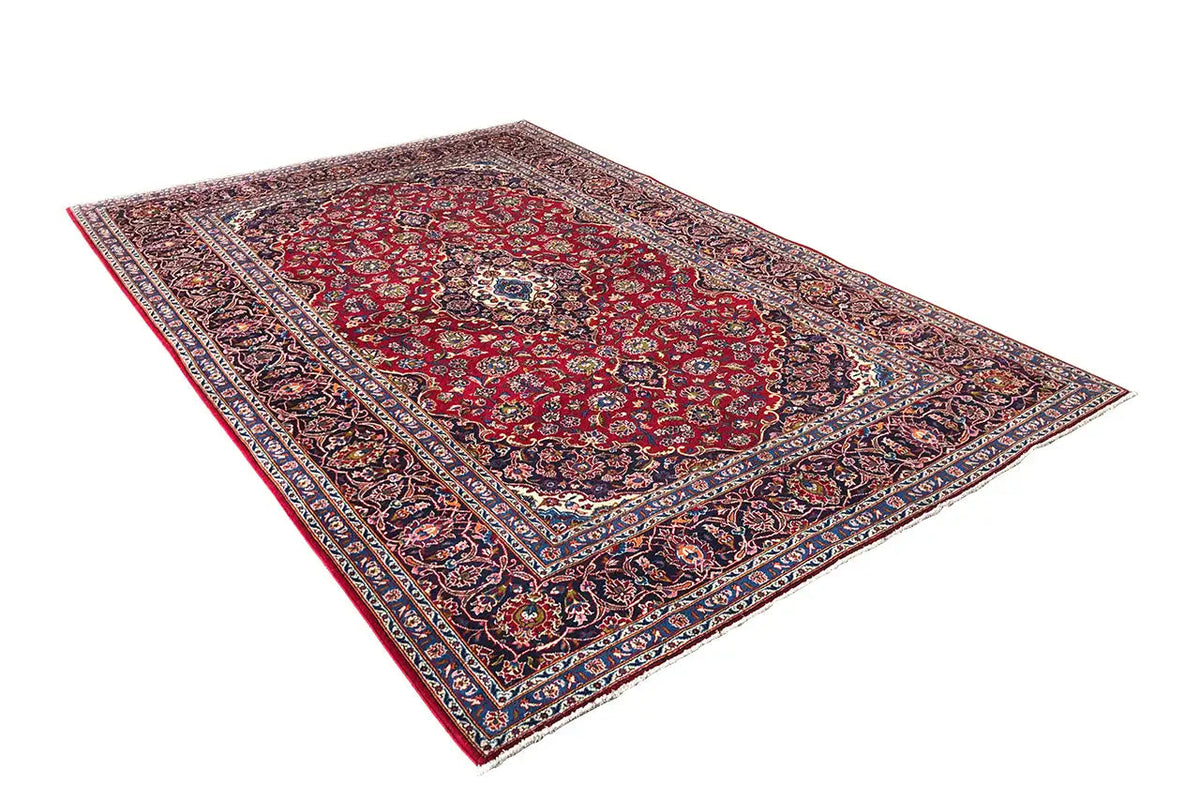 Red Keshan rug with light ornament bands and a blue decorative frieze