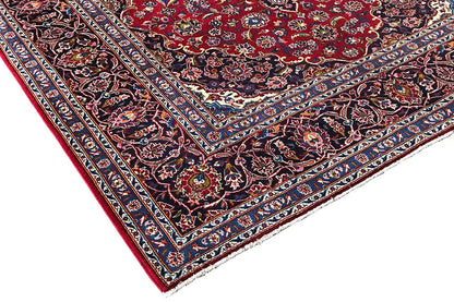 Keshan rug corner, red with a dark blue border and delicate floral ornaments