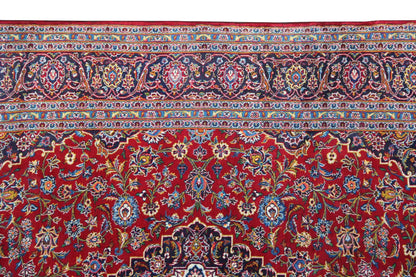 Red Keshan rug with a border of vines and medallions along the upper edge