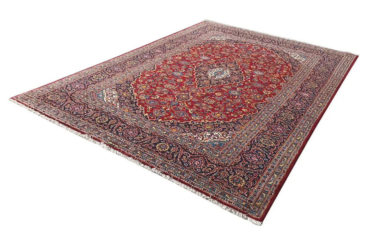 Keshan rug in red with angular corner details, a central medallion, and borders