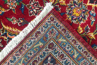 Keshan rug in red with close-up: colorful ornaments and fringes