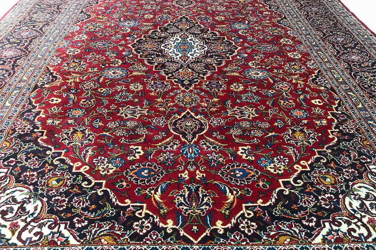 Keshan rug in red with a central medallion and delicate floral pattern gradient