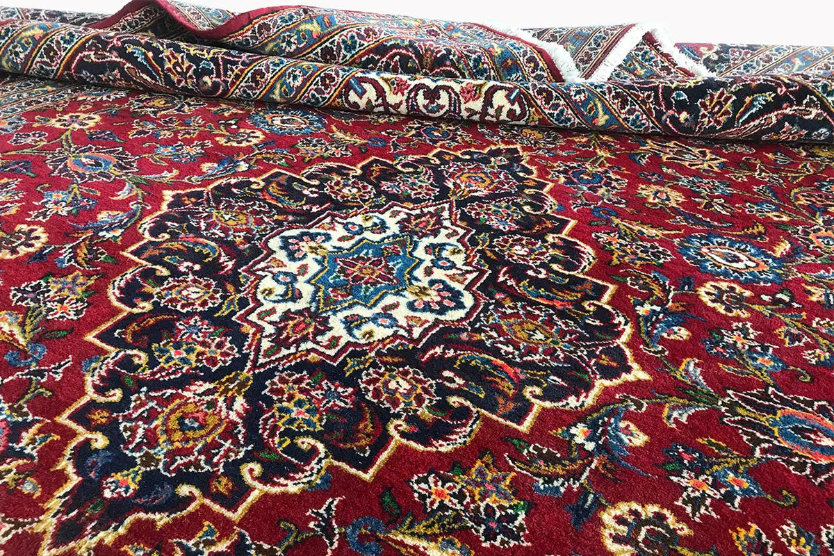 Red Keshan rug with a central medallion and delicate ornaments
