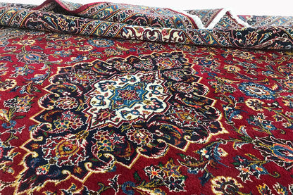 Red Keshan rug with a central medallion and delicate ornaments