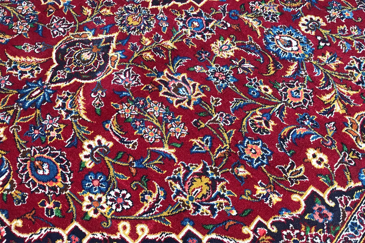 Keshan rug in red with intricate floral patterns in close-up
