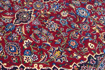 Keshan rug in red with intricate floral patterns in close-up