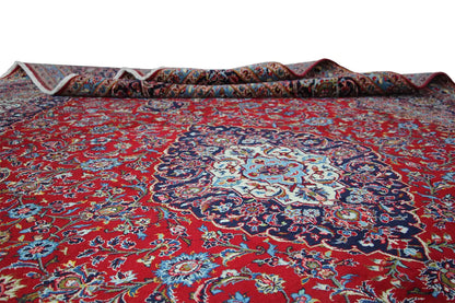 Keshan rug in red with medallion; turned-up corner shows the rug pile.