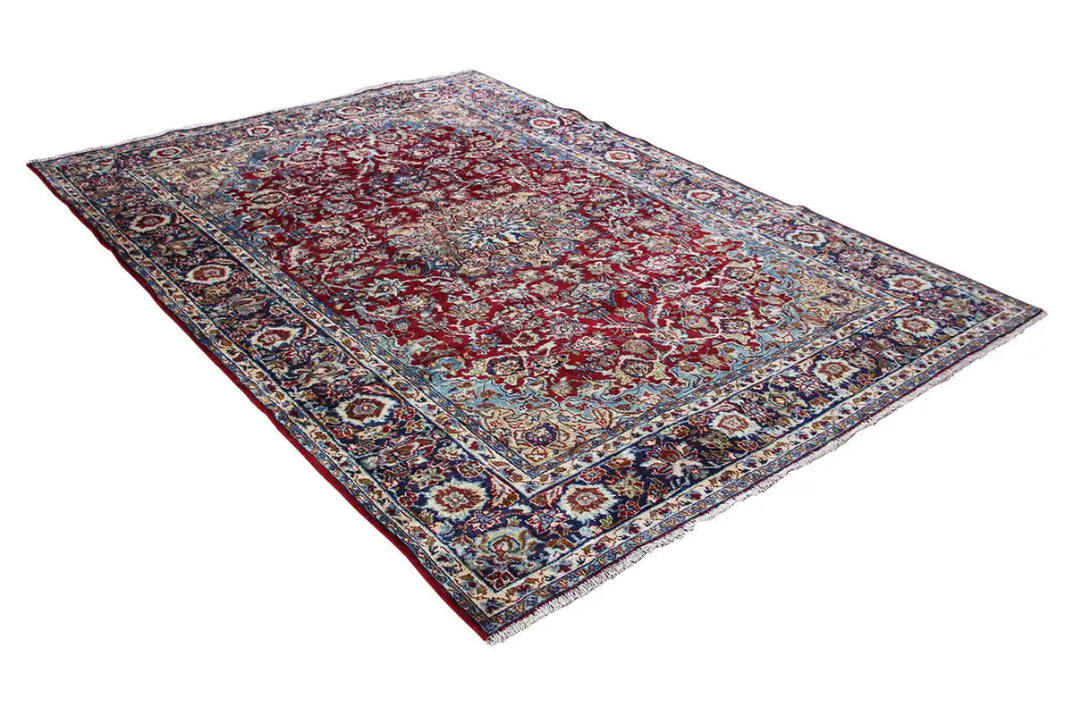 Oriental rug corner with red, blue, and beige ornaments, framed in a rectangle.