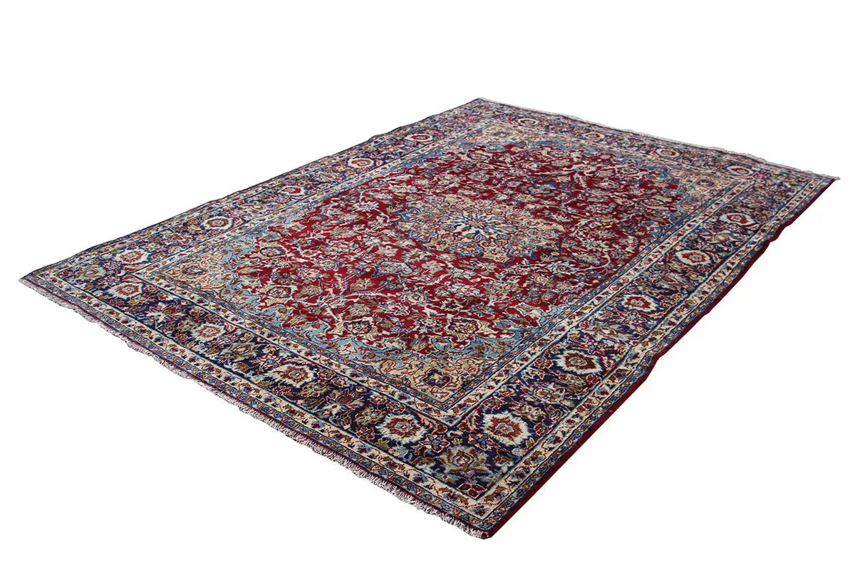 Red-and-blue ornamental field of an Oriental rug with a multicolored border design.