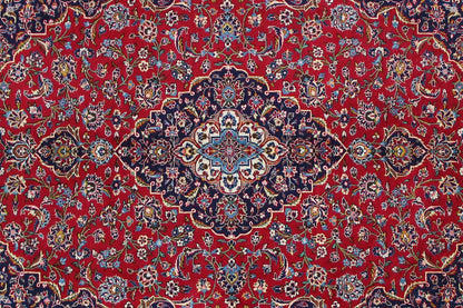 Close-up of a carpet pattern: red background with blue and gold floral ornaments