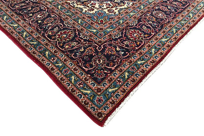 Corner view of Keshan rug: red border with turquoise lines and multicolored ornaments