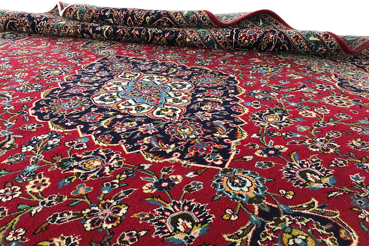 Carpet surface with an open border: red pattern with a blue central medallion and embellishments