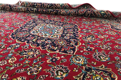 Carpet surface with an open border: red pattern with a blue central medallion and embellishments