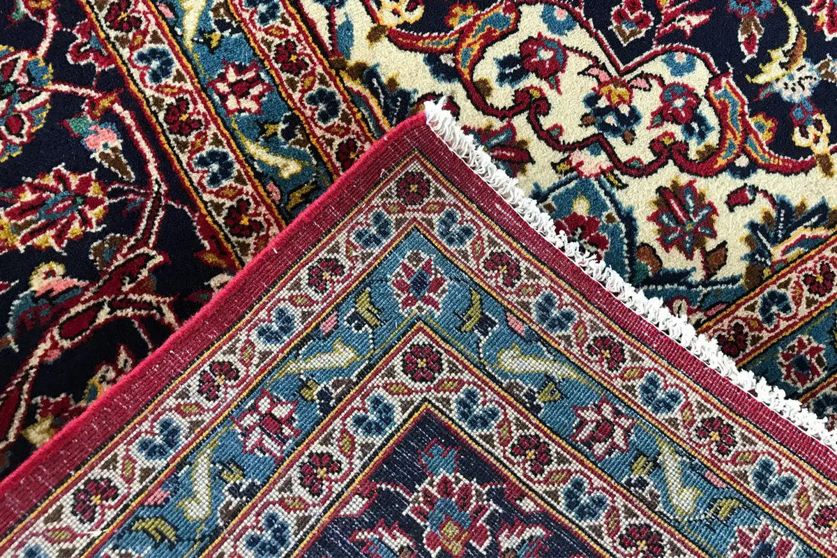 Close-up of a carpet edge with colorful patterns and a decorative border finish