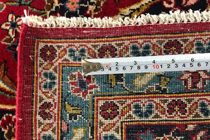 Close-up of hem edge with measurement display and embroidered ornamental panels