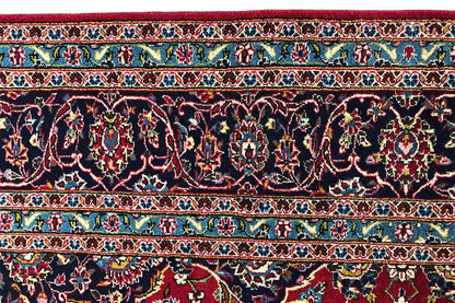 Border view of carpet: dark blue background with red, green, and gold vines