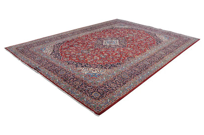 Keshan rug with a red center and ornate border, rectangular (diagonal).