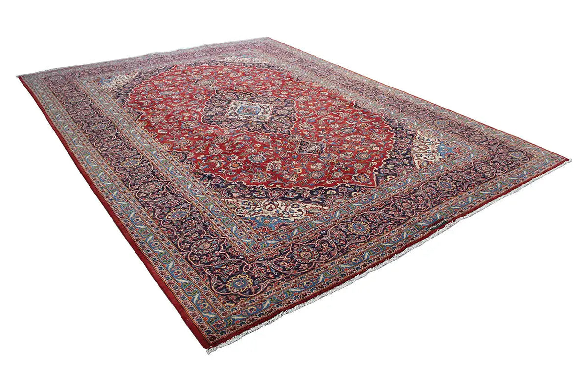 Keshan rug with red medallion and blue-gray border, rectangular.