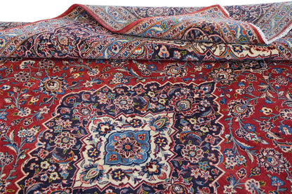 Keshan oriental rug in red with a blue pattern, knotted, folded view