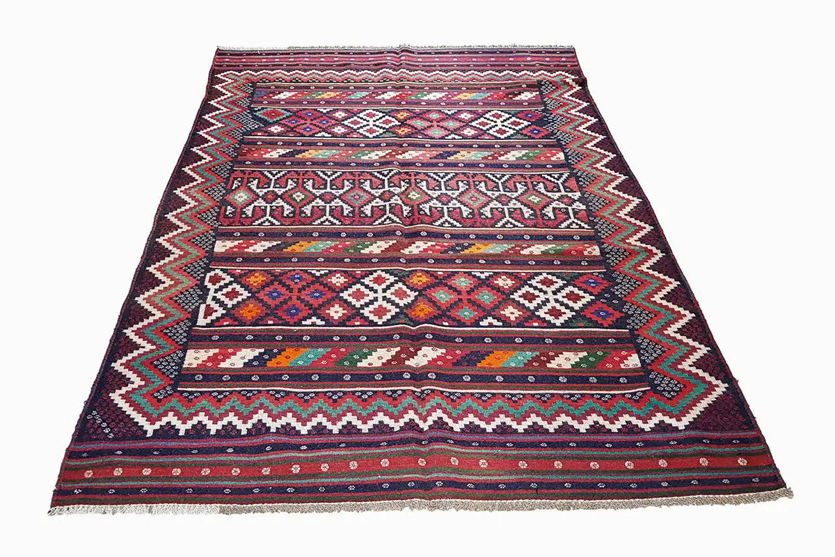 Kilim rug with wide stripes and small ornaments; dark blue base, fringes at the corners.