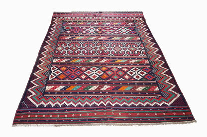 Kilim rug with wide stripes and small ornaments; dark blue base, fringes at the corners.