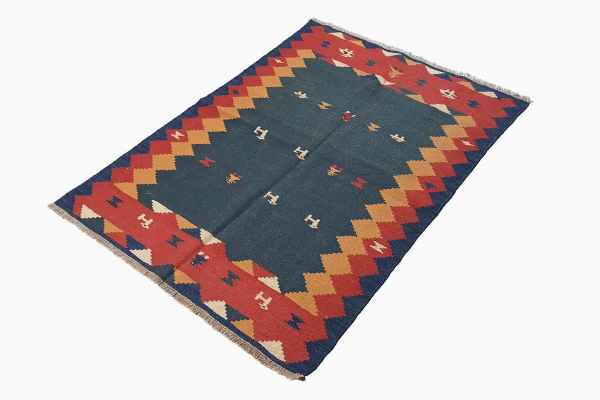 Kilim rug with a blue background, zigzag border, and red, yellow, and beige patterns