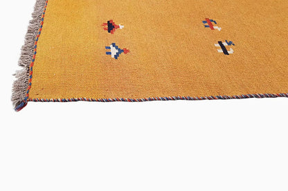 Kilim rug border in ochre brown with colorful patterns and frayed edges