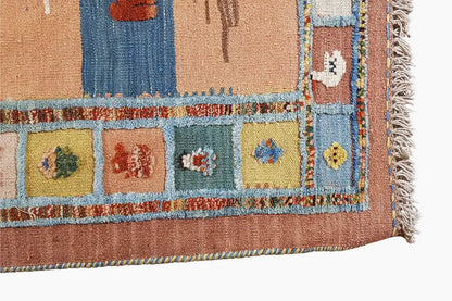 Corner section of a kilim rug with colorful ornaments and a side fringe border
