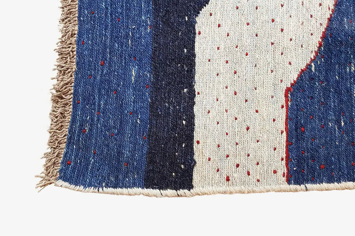 Kilim rug with fringes, blue-and-white areas, and red contour lines